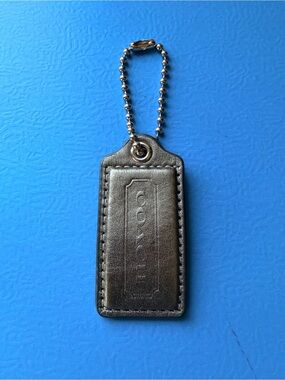 Coach hangtag, metallic pewter color, one sided logo